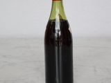 a bottle of wine sitting on a counter top