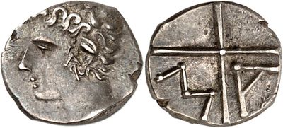 a silver coin with an image of a woman and a cross on it
