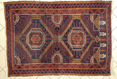 a close up of a rug on a tiled floor