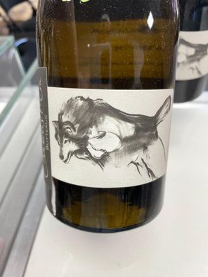 a bottle of wine with a drawing of a cat on it