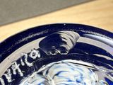 a close up of a glass with a blue and white design on it