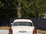 a white car that is parked on the side of the road