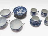 a group of blue and white dishes and cups