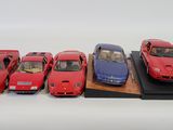 five different models of cars on display on a wooden stand