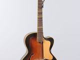 an old mandolin guitar sitting on a stand against a white background