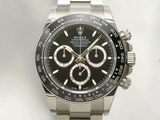 rolex watch with black dial and stainless bracelet on a white background