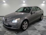 the mercedes c - class is parked on a checkered tile floor