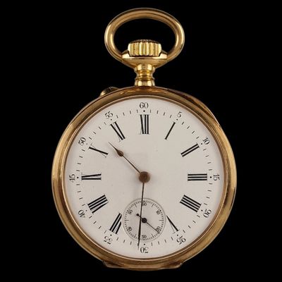 a gold pocket watch with roman numerals on the face