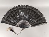 a black fan with a white design on it