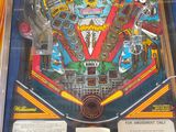 a pinball machine in a glass case on display