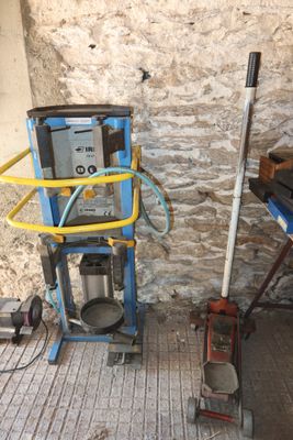 a picture of a room with a blue cart and a yellow hose