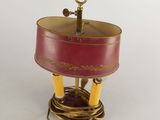 an image of a red and gold lamp on a white surface
