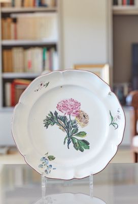une assiette ornée d'une fleur, posée sur une table