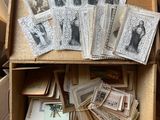 a box full of old photos and cards on the floor