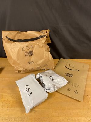 a brown bag and some white bags on a table