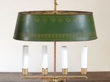 a green lamp that is on a wooden table