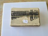 an old photo of a group of men standing in front of a crowd of people