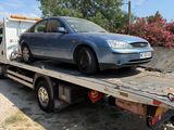 a blue car on the back of a flatbed tow truck