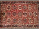 an antique persian rug with a red and blue design