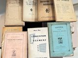 several old books are stacked on top of each other on a table
