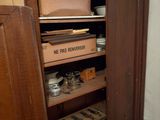 a wooden cabinet with a lot of items in it