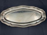 an antique silver plate on a black background with a black background