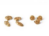 a pair of gold cufflinks and a pair of earrings