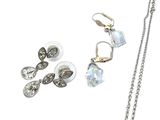 three pieces of jewelry including a necklace, earrings, and a ring