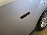 a close up of a car door with a sticker on it