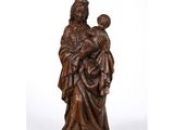 a wooden statue of a woman holding a child