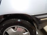 a close up of a white car with a flat tire