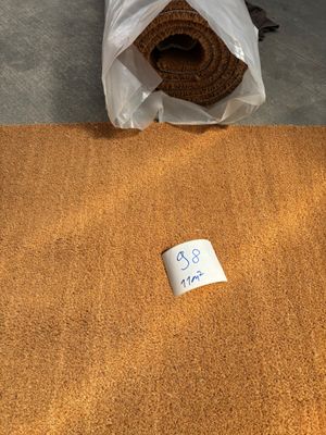 a roll of carpet on the floor next to a roll of carpet
