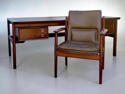 a desk with a chair and a table with a drawer on it