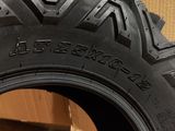 a close up of a tire on a wooden floor with a wall in the background