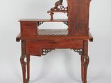 an old wooden desk with a mirror on top of it