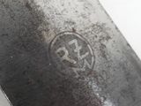 a close up of a knife on a white surface