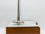 a small table with a metal object on top of it