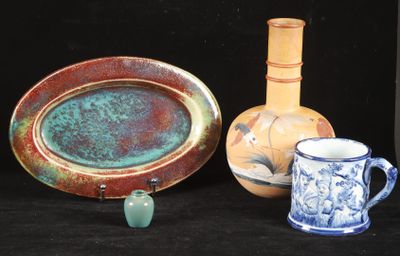 three vases and a plate on a black background