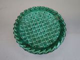 a green plate with a woven design on it