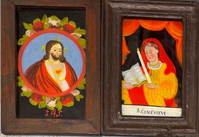 two paintings of jesus and mary in a wooden frame on a wall