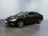 the black car is parked in a large room with a white wall