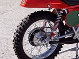a red dirt bike parked on the side of the road