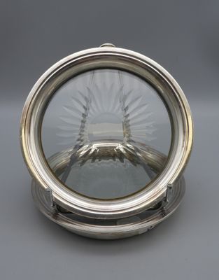 a close up of a silver plate with a glass dome on it