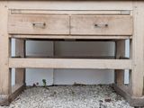 a wooden table with two drawers underneath it