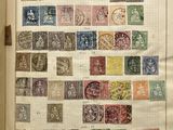 an open book with a bunch of stamps on it sitting on top of a table