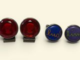 three pairs of cufflinks with the names of three different countries