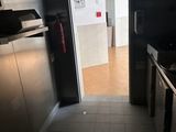 a door leading into a kitchen with a sink and a stove