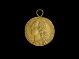 gros plan d'une pièce d'or portant un visage de femme