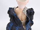 a white vase sitting on top of a mannequin head