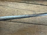 a close up of a pair of scissors on a wooden table